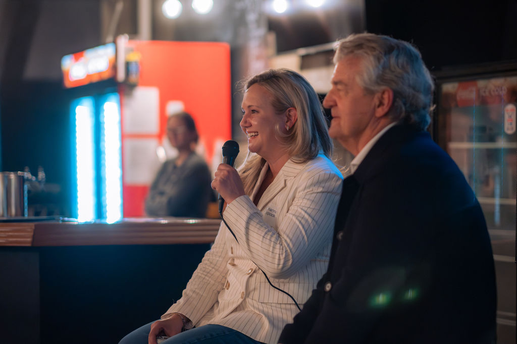 Marianne Coppock and Bruce Sherman on stage at the Spring 2026 event