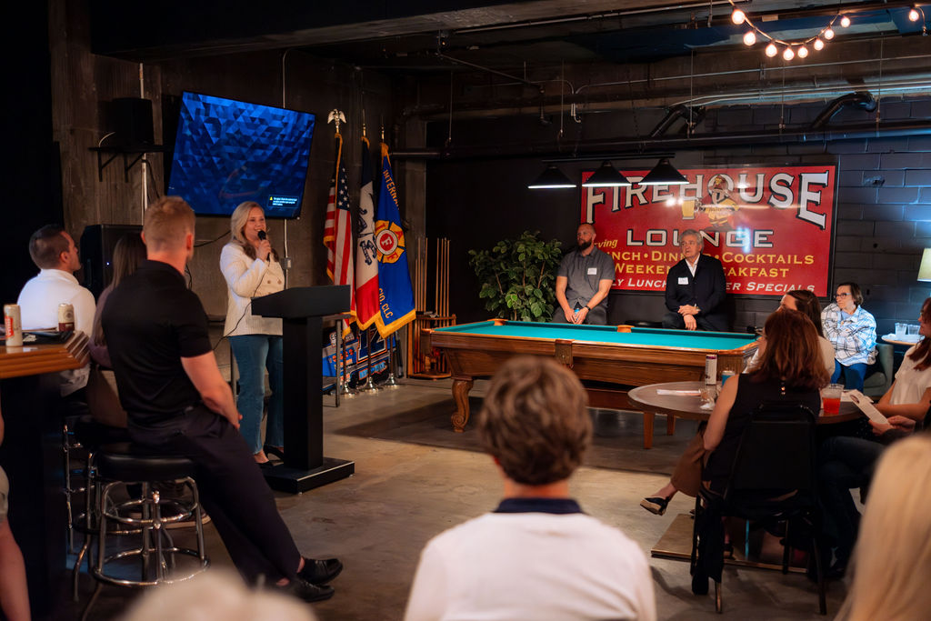 A speaker addressing the audience at The Shop DSM