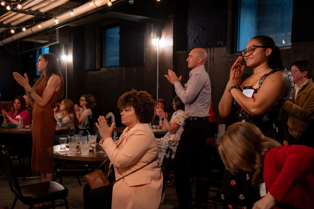 Attendees applauding at the Spring 2026 event